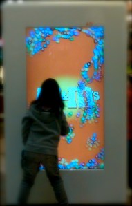 Kid playing with a life size outdoor display in a mall